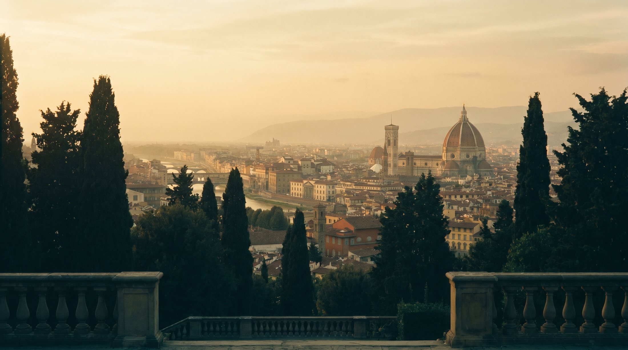 Terracotta rooftops and the Duomo of Florence at golden dusk