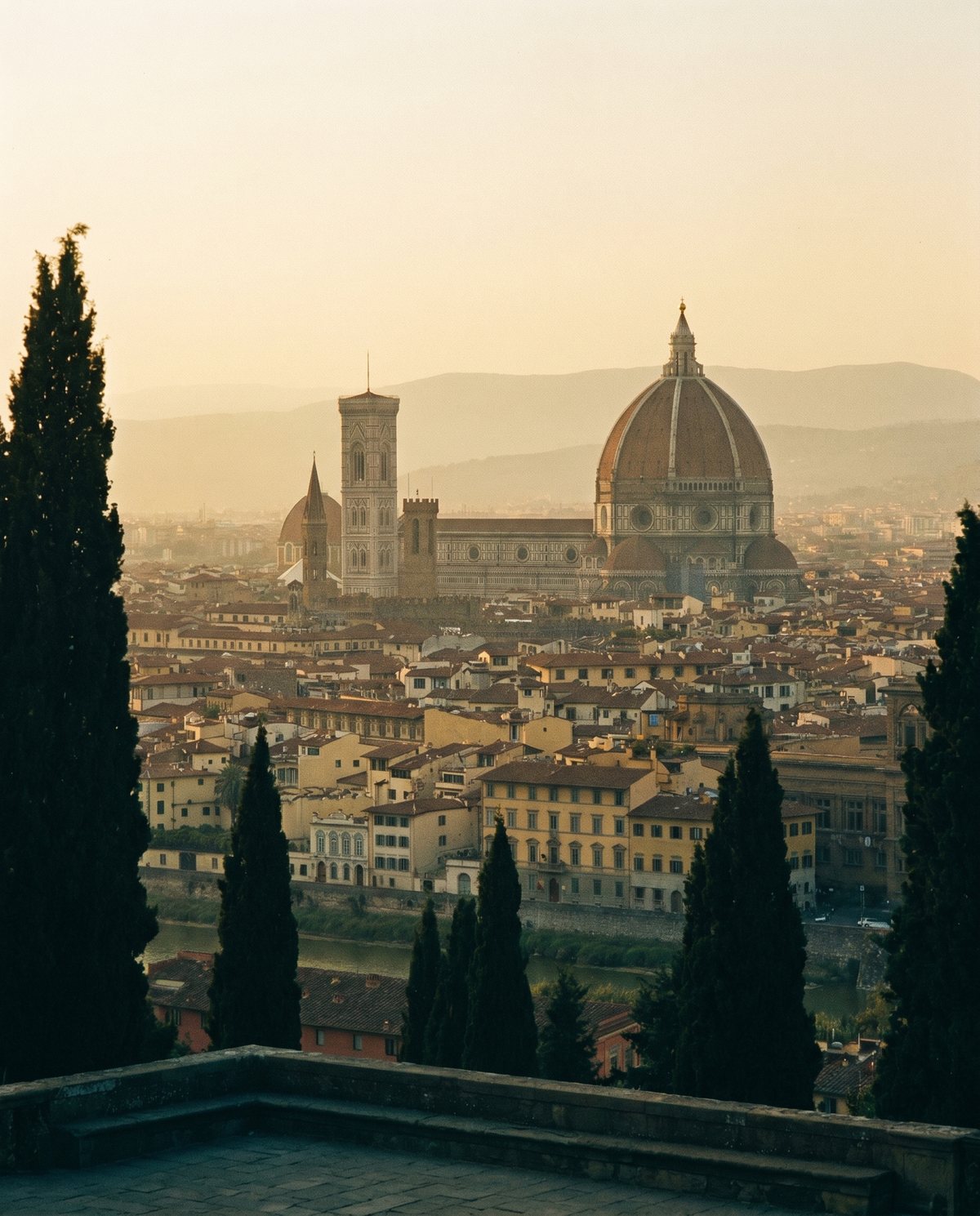 Terracotta rooftops and the Duomo of Florence at dusk