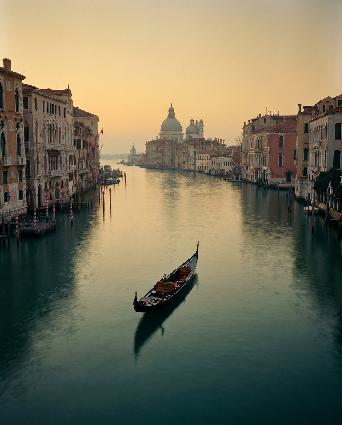 A lone gondola on a quiet Venetian canal at dusk